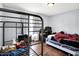 Bedroom with bunkbeds, hardwood floors, white curtains, and a desk offers a functional living space at 602 Pioneer Dr, Indianapolis, IN 46217