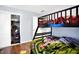 Bedroom with a bunk bed, hardwood floors, an open closet, and a door entrance at 602 Pioneer Dr, Indianapolis, IN 46217