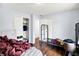 A bedroom features hardwood floors, light blue walls, and white closets for ample storage at 602 Pioneer Dr, Indianapolis, IN 46217