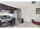 Spacious kitchen with stainless steel appliances including refrigerator and oven, plus tiled floors and a storage area at 602 Pioneer Dr, Indianapolis, IN 46217