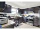 Traditional kitchen features dark wood cabinets, stainless steel appliances, and a double sink with window view at 602 Pioneer Dr, Indianapolis, IN 46217