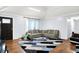 Bright living room featuring hardwood floors, modern gray sofa, and a large, patterned area rug at 602 Pioneer Dr, Indianapolis, IN 46217