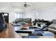 Spacious living room with vaulted ceiling, hardwood floors, modern sofas, stylish rug, and ceiling fan at 602 Pioneer Dr, Indianapolis, IN 46217