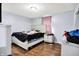 A tidy main bedroom with white furniture, hardwood floors, and neutral walls offers a serene atmosphere at 602 Pioneer Dr, Indianapolis, IN 46217