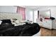 Relaxing main bedroom with soft blue walls, hardwood floors, and white furniture with a mirrored dresser at 602 Pioneer Dr, Indianapolis, IN 46217