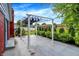 A covered patio space extends into a lush backyard with manicured green bushes and trees at 602 Pioneer Dr, Indianapolis, IN 46217