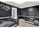 Sitting area with dark walls, tiled floors, a modern sofa, and a pantry door, blending functionality with style at 602 Pioneer Dr, Indianapolis, IN 46217