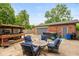 Relaxing backyard with a patio set, barbecue, detached garage, and hot tub at 615 E Stop 11 Rd, Indianapolis, IN 46227