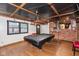 Entertaining basement space featuring a pool table, brick accents, and cozy ambiance at 615 E Stop 11 Rd, Indianapolis, IN 46227