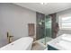 Luxurious bathroom featuring a standalone tub, glass-enclosed shower, and elegant fixtures at 615 E Stop 11 Rd, Indianapolis, IN 46227