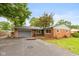 Charming single-story brick home featuring an attached garage and a cozy front patio at 615 E Stop 11 Rd, Indianapolis, IN 46227