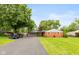 Charming brick home with a long driveway, well-manicured lawn, and attached garage at 615 E Stop 11 Rd, Indianapolis, IN 46227