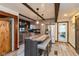 Modern kitchen featuring a large island with seating, stainless steel appliances, and unique beamed ceiling at 615 E Stop 11 Rd, Indianapolis, IN 46227