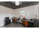 Bright office space with decorative ceiling tiles, wood-look floors, and two desk areas at 615 E Stop 11 Rd, Indianapolis, IN 46227