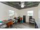 Office space with decorative ceiling tiles, two windows, and two desks at 615 E Stop 11 Rd, Indianapolis, IN 46227