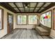 Bright sunroom with a comfortable sofa, large windows, and rustic-chic decor at 615 E Stop 11 Rd, Indianapolis, IN 46227