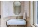 Stylish powder room featuring a white vanity with brass hardware and decorative wallpaper at 625 E 57Th St, Indianapolis, IN 46220