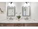 Elegant bathroom with a double vanity, decorative mirrors, quartz countertops, and modern fixtures at 625 E 57Th St, Indianapolis, IN 46220