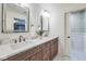 Bathroom with double vanity, marble countertop, decorative mirrors, and stylish wallpaper in the toilet room at 625 E 57Th St, Indianapolis, IN 46220