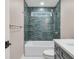 Contemporary bathroom showcasing blue tiled walls, modern fixtures, and a sleek design, creating a tranquil retreat at 625 E 57Th St, Indianapolis, IN 46220