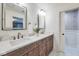 Bathroom with double vanity, marble countertop, decorative mirrors, and stylish wallpaper in the toilet room at 625 E 57Th St, Indianapolis, IN 46220