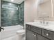 Modern bathroom with blue tile, white countertop, and updated fixtures in a contemporary design at 625 E 57Th St, Indianapolis, IN 46220