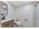 This modern bathroom features a vanity, toilet, and glass enclosed shower with white tiling at 625 E 57Th St, Indianapolis, IN 46220