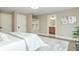 Bright bedroom featuring a neutral color scheme, with a glimpse into an en-suite bathroom and modern decor at 625 E 57Th St, Indianapolis, IN 46220
