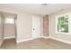 Cozy bedroom with a brick accent wall, hardwood floors, natural light, and neutral paint at 625 E 57Th St, Indianapolis, IN 46220