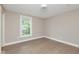 This light filled bedroom features neutral walls, hardwood floors, and a window overlooking the outdoors at 625 E 57Th St, Indianapolis, IN 46220