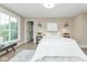 Well-lit bedroom with a large window, neutral colors, a comfortable bed, and modern decor at 625 E 57Th St, Indianapolis, IN 46220