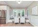 Bright dining area with built-in bench seating and views of the backyard at 625 E 57Th St, Indianapolis, IN 46220