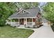 Charming home featuring a classic red exterior, inviting front porch, and well-maintained landscaping at 625 E 57Th St, Indianapolis, IN 46220