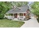 Charming two-story home with a covered front porch and well-manicured landscaping at 625 E 57Th St, Indianapolis, IN 46220