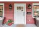 Close-up of a charming front porch with decorative lighting, potted plants, and stylish front door at 625 E 57Th St, Indianapolis, IN 46220