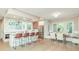 Bright kitchen with stainless steel appliances, center island with seating, and adjacent dining area at 625 E 57Th St, Indianapolis, IN 46220