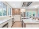 Bright kitchen with stainless steel appliances and a large island with barstool seating, flowing into the dining area at 625 E 57Th St, Indianapolis, IN 46220