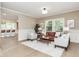 Bright living room featuring hardwood floors, modern furniture, and an open layout leading to the kitchen at 625 E 57Th St, Indianapolis, IN 46220