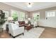 Bright and open living room featuring hardwood floors, comfortable seating, and large windows at 625 E 57Th St, Indianapolis, IN 46220