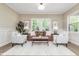 Elegant living room showcasing neutral tones, stylish furnishings, and ample natural light at 625 E 57Th St, Indianapolis, IN 46220