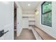 Well-organized mudroom with built-in bench, storage cubbies, and natural light at 625 E 57Th St, Indianapolis, IN 46220