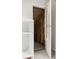 Unfinished attic space with insulation, storage, and an ironing board at 6307 Keeneland Ct, Indianapolis, IN 46278