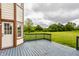 Open back deck provides scenic views of green lawn with tree line at 6307 Keeneland Ct, Indianapolis, IN 46278