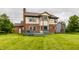 Spacious backyard featuring a two-story home with a brick and siding exterior and a wooden deck at 6307 Keeneland Ct, Indianapolis, IN 46278