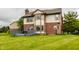 Lush backyard featuring a two-story home with brick accents, light siding, and a wooden deck at 6307 Keeneland Ct, Indianapolis, IN 46278