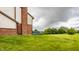 Wide green backyard, with a wooden deck, backing up to a tree line at 6307 Keeneland Ct, Indianapolis, IN 46278