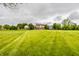 Vast grassy backyard surrounding a suburban home with lots of space for outdoor activities at 6307 Keeneland Ct, Indianapolis, IN 46278