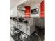 Contemporary basement bar area with sleek gray cabinets, modern seating, and a TV at 6307 Keeneland Ct, Indianapolis, IN 46278