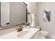 Cozy bathroom featuring a pedestal sink, framed mirror, and neutral decor at 6307 Keeneland Ct, Indianapolis, IN 46278