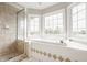 Bright bathroom boasts a tub, enclosed shower and bay window for natural light at 6307 Keeneland Ct, Indianapolis, IN 46278